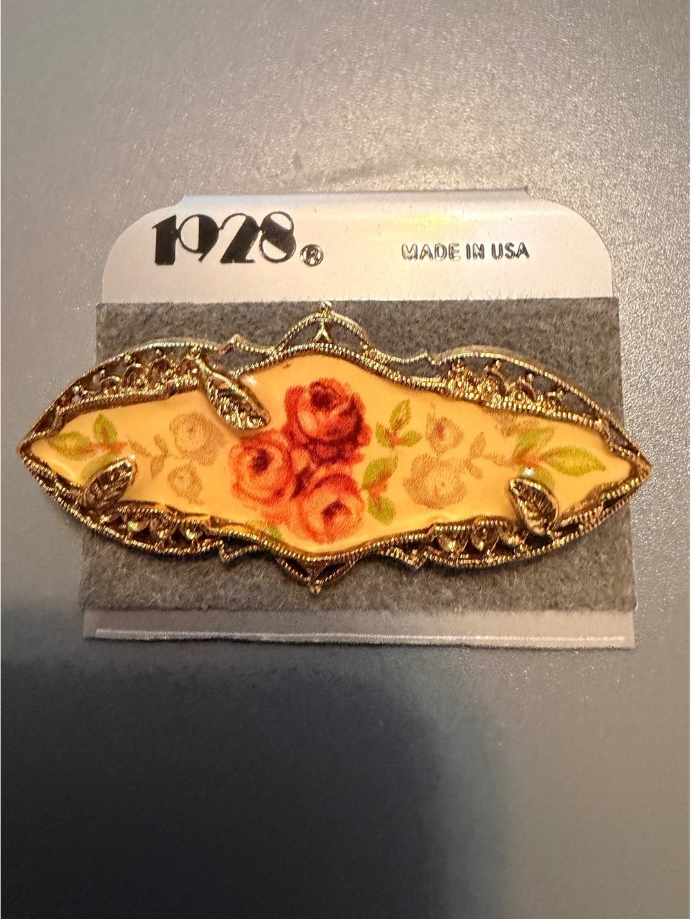Vintage 1928 Floral Gold Tone pin in original packaging